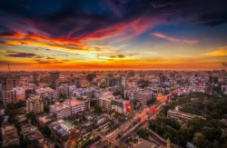 This picture shows an overview of Dhaka alongside a beautiful sunset