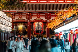 Visitors walk around the famous Asakusa Temple located in the heart of Tokyo, Japan
